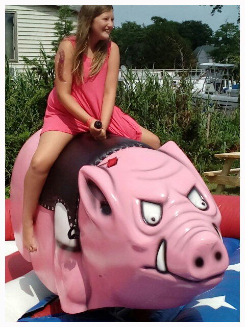 Guest riding the pink mechanical pig